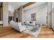 Open living room with high ceilings, stone accents, hardwood floors and modern white furnishings at 4766 S Fillmore Ct, Cherry Hills Village, CO 80113