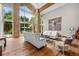 Bright living room featuring soaring ceilings, floor-to-ceiling windows, and elegant decor with backyard pool view at 4766 S Fillmore Ct, Cherry Hills Village, CO 80113