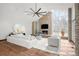 Cozy living room with stone fireplace, large windows, and comfortable white seating at 4766 S Fillmore Ct, Cherry Hills Village, CO 80113