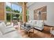 Bright living room featuring soaring ceilings, floor-to-ceiling windows, and elegant decor with backyard pool view at 4766 S Fillmore Ct, Cherry Hills Village, CO 80113