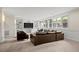 Spacious living room featuring a large sectional sofa, built-in shelving, and natural light from the windows at 4766 S Fillmore Ct, Cherry Hills Village, CO 80113