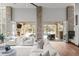 Elegant living room with stone accents and seamless indoor-outdoor flow to pool at 4766 S Fillmore Ct, Cherry Hills Village, CO 80113