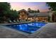 Exterior view of a luxurious home with a beautiful pool and outdoor living space for entertaining at 4766 S Fillmore Ct, Cherry Hills Village, CO 80113