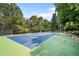 Well-maintained tennis court surrounded by lush greenery, perfect for sports enthusiasts at 4766 S Fillmore Ct, Cherry Hills Village, CO 80113