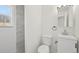 Bright bathroom with white vanity, toilet, and tiled shower with window at 1524 Twin Sisters Dr, Longmont, CO 80504