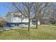 Traditional home with a gray foundation, white siding, and a well-kept lawn at 1524 Twin Sisters Dr, Longmont, CO 80504