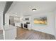Modern kitchen with white cabinets, stainless steel appliances, and a scenic backyard view at 1524 Twin Sisters Dr, Longmont, CO 80504