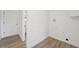 Bright laundry room with laminate wood floors and ample wall sockets at 1524 Twin Sisters Dr, Longmont, CO 80504
