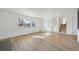 Open living room with hardwood floors, large window, and view of stairs at 1524 Twin Sisters Dr, Longmont, CO 80504