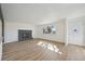 Bright living room offers fresh paint, new flooring, lots of natural light, and a brick fireplace at 1524 Twin Sisters Dr, Longmont, CO 80504
