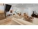Spacious basement living area with modern furnishings, wooden floors, and staircase at 735 S Elizabeth St, Denver, CO 80209