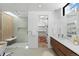 Modern bathroom with dual vanity, glass shower, and wood-look tile at 735 S Elizabeth St, Denver, CO 80209