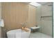 Bright bathroom featuring a soaking tub, walk-in shower, skylight, and sleek tile work at 735 S Elizabeth St, Denver, CO 80209