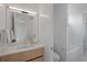 Well-lit bathroom with modern vanity, large mirror, and access to the shower and bathtub area at 735 S Elizabeth St, Denver, CO 80209