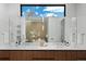 Bright bathroom with double vanity, wood cabinets, and soaking tub reflected in large mirror at 735 S Elizabeth St, Denver, CO 80209