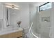 Bright bathroom with modern vanity, large mirror, and glass-enclosed shower with a window at 735 S Elizabeth St, Denver, CO 80209