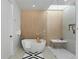 Modern bathroom features a soaking tub, walk-in shower, skylight, and sleek tile work at 735 S Elizabeth St, Denver, CO 80209