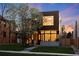 Modern two-story home with a manicured lawn, beautiful flowering tree, and inviting entrance at 735 S Elizabeth St, Denver, CO 80209