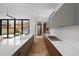 Long kitchen view with a large island, integrated stovetop, and open backyard at 735 S Elizabeth St, Denver, CO 80209