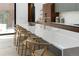 Kitchen island with bar stool seating, quartz countertop, and designer faucet at 735 S Elizabeth St, Denver, CO 80209