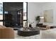 Modern living room with a decorative fireplace, minimalist art, and designer furnishings at 735 S Elizabeth St, Denver, CO 80209