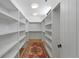Spacious walk-in closet with custom shelving, wood floors, and a decorative rug at 735 S Elizabeth St, Denver, CO 80209