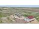 Property aerial view showcasing home, shop, and surrounding countryside, highlighting the peace and seclusion at 62681 E Hampden Pl, Byers, CO 80103