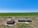 Wide aerial view of property with home, large shop, and vast fields, highlighting the extensive acreage at 62681 E Hampden Pl, Byers, CO 80103