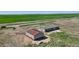 Expansive aerial view of property featuring home, large shop, and surrounding fields, offering a sense of space at 62681 E Hampden Pl, Byers, CO 80103