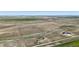 Expansive aerial view of the property showcasing the residence, outbuildings and land at 62681 E Hampden Pl, Byers, CO 80103