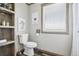 Cozy bathroom featuring wood-look flooring, neutral walls, and modern fixtures, complemented by unique animal art at 62681 E Hampden Pl, Byers, CO 80103