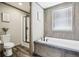 Modern bathroom featuring a soaking tub with tile surround and a glass-enclosed shower at 62681 E Hampden Pl, Byers, CO 80103