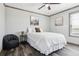 Well-lit bedroom featuring wood floors, ceiling fan, and a comfortable bed with a highland cow print at 62681 E Hampden Pl, Byers, CO 80103