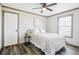 Serene bedroom with a ceiling fan and natural light from a window with wood floors at 62681 E Hampden Pl, Byers, CO 80103