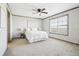 Spacious bedroom with neutral carpeting, plenty of natural light, and minimalist decor at 62681 E Hampden Pl, Byers, CO 80103