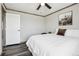 Bright bedroom with a highland cow print and comfortable bed, with wood floors and a door frame at 62681 E Hampden Pl, Byers, CO 80103