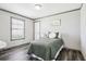 Bright bedroom with a large window and comfortable furnishings, featuring wood flooring and white trim at 62681 E Hampden Pl, Byers, CO 80103