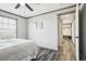 Bright bedroom with a ceiling fan leading into closet area, with wood flooring and large windows at 62681 E Hampden Pl, Byers, CO 80103