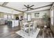 Comfortable dining room with wood-look flooring, decorative wood beams, and modern light fixtures at 62681 E Hampden Pl, Byers, CO 80103