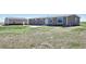 Home exterior with generous grassy area, showcasing the spacious lot and its potential for outdoor activities at 62681 E Hampden Pl, Byers, CO 80103