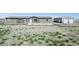 View of the front exterior of the home with a large yard and detached garage at 62681 E Hampden Pl, Byers, CO 80103