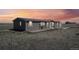 Dusk view of home showcasing updated exterior and landscaping at 62681 E Hampden Pl, Byers, CO 80103
