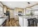Beautiful kitchen features wood cabinets, stainless appliances, and a center island with seating at 62681 E Hampden Pl, Byers, CO 80103