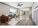 Inviting living room featuring leather furniture, hardwood floors, and large windows at 62681 E Hampden Pl, Byers, CO 80103