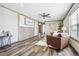 Comfortable living room with wood trim, ceiling fan, and modern decor at 62681 E Hampden Pl, Byers, CO 80103