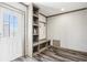 Spacious mudroom with built-in storage and bench, featuring stylish decor and convenient access to the outside at 62681 E Hampden Pl, Byers, CO 80103