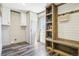 Well-organized mudroom showcasing built-in bench and shelving for storage, alongside convenient laundry facilities at 62681 E Hampden Pl, Byers, CO 80103