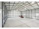 Bright shop interior with high ceilings, providing ample space for projects, storage, and equipment, with natural light at 62681 E Hampden Pl, Byers, CO 80103