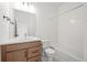 Bright bathroom with a vanity, a mirror and a shower and tub combo with tile backsplash at 2736 W 68Th Ave, Denver, CO 80221