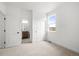 Bright bedroom with a view of a bathroom, two doors, and a window with natural light at 2736 W 68Th Ave, Denver, CO 80221